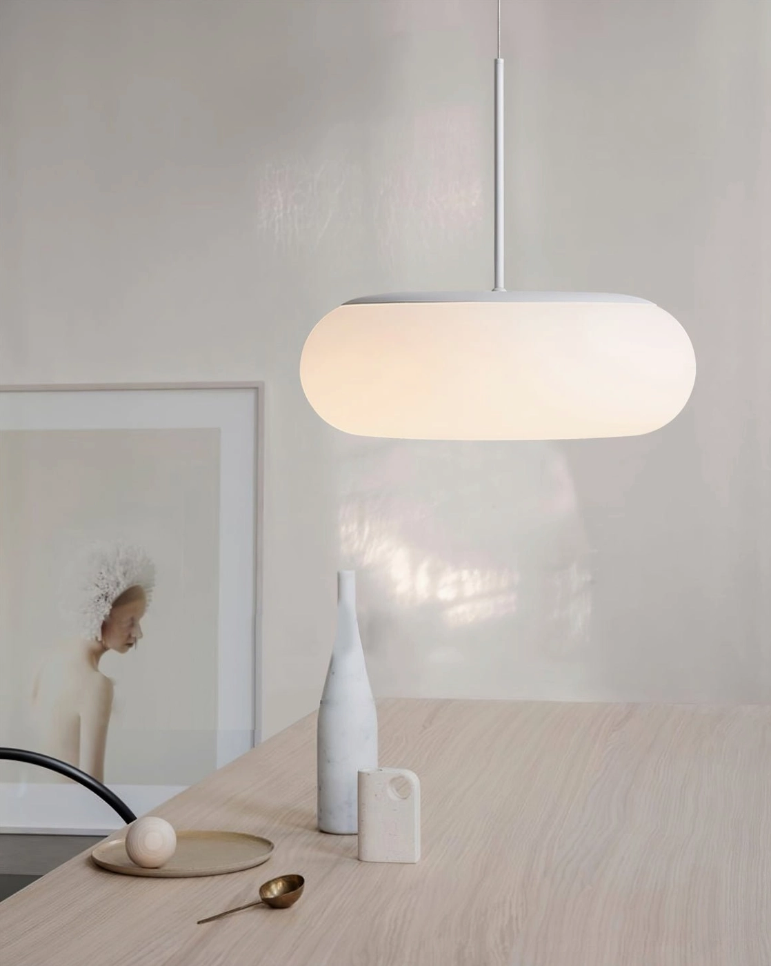 Amor white oval pendant lamp showing wire suspension adjustment and ceiling mounting compatibility