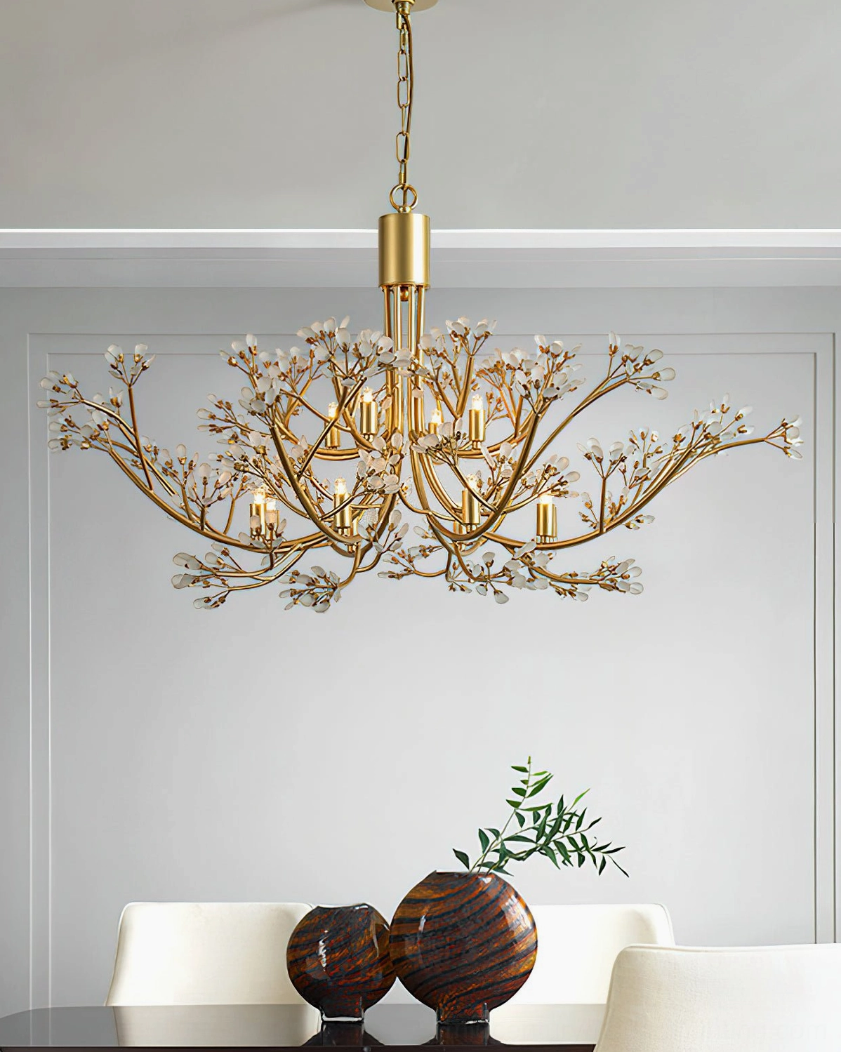 Anais branch-inspired crystal chandelier above dining room table with place settings and elegant tableware