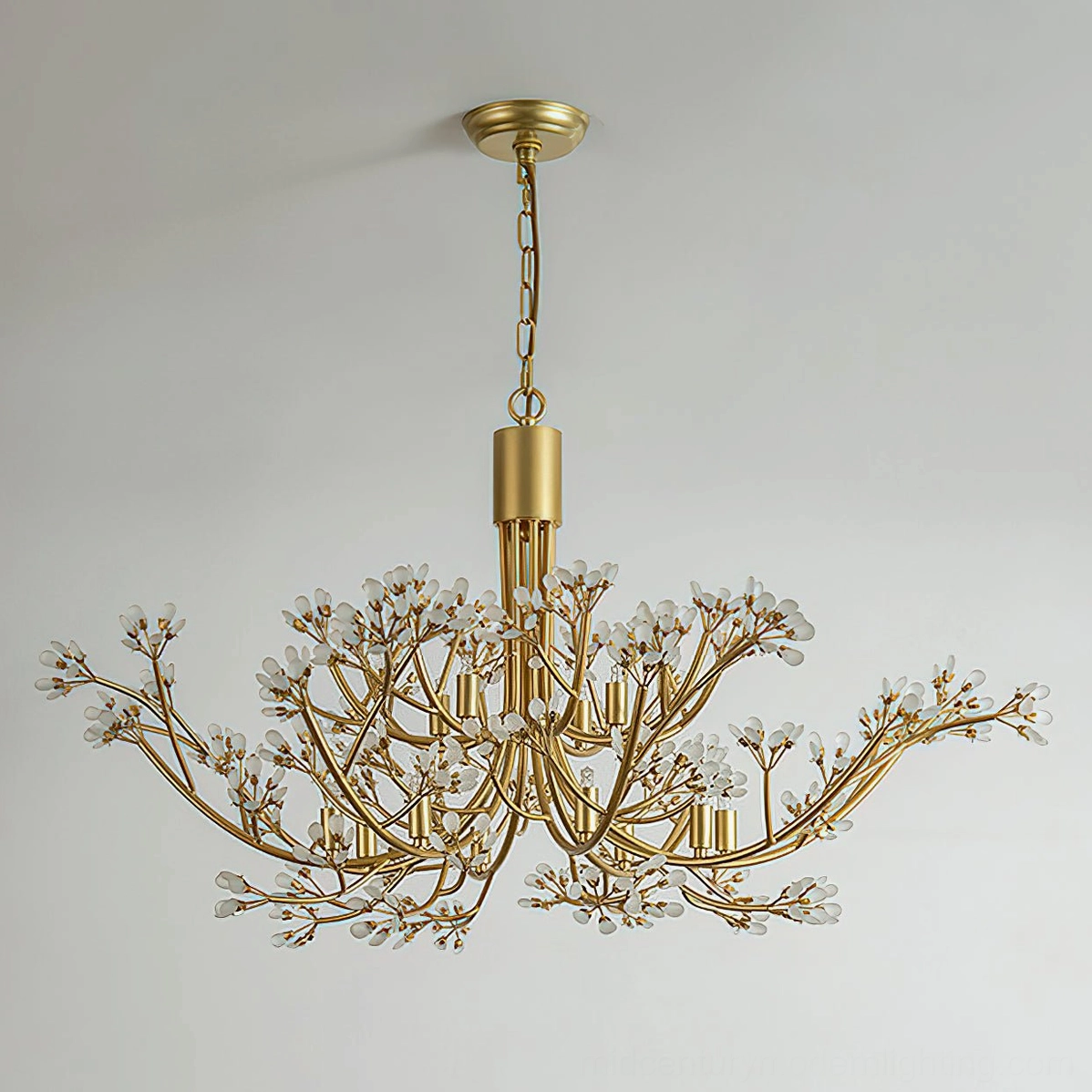 Anais crystal chandelier installed in modern minimalist white interior, showcasing warm brass patina and light refraction through crystals