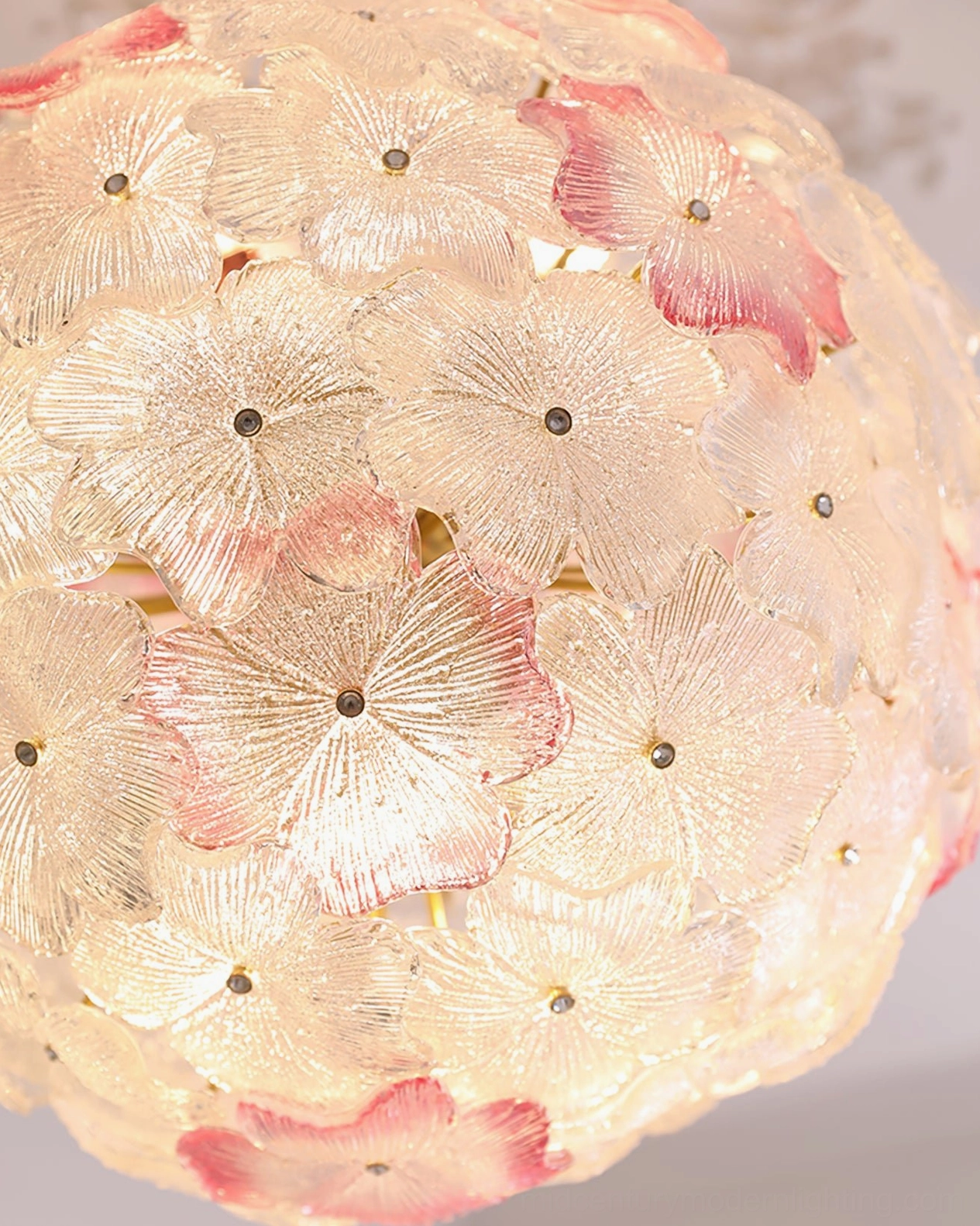 Anan Floral Chandelier close-up detail, hand-blown glass petals with pink gradient centers, textured surface, metal flower accents