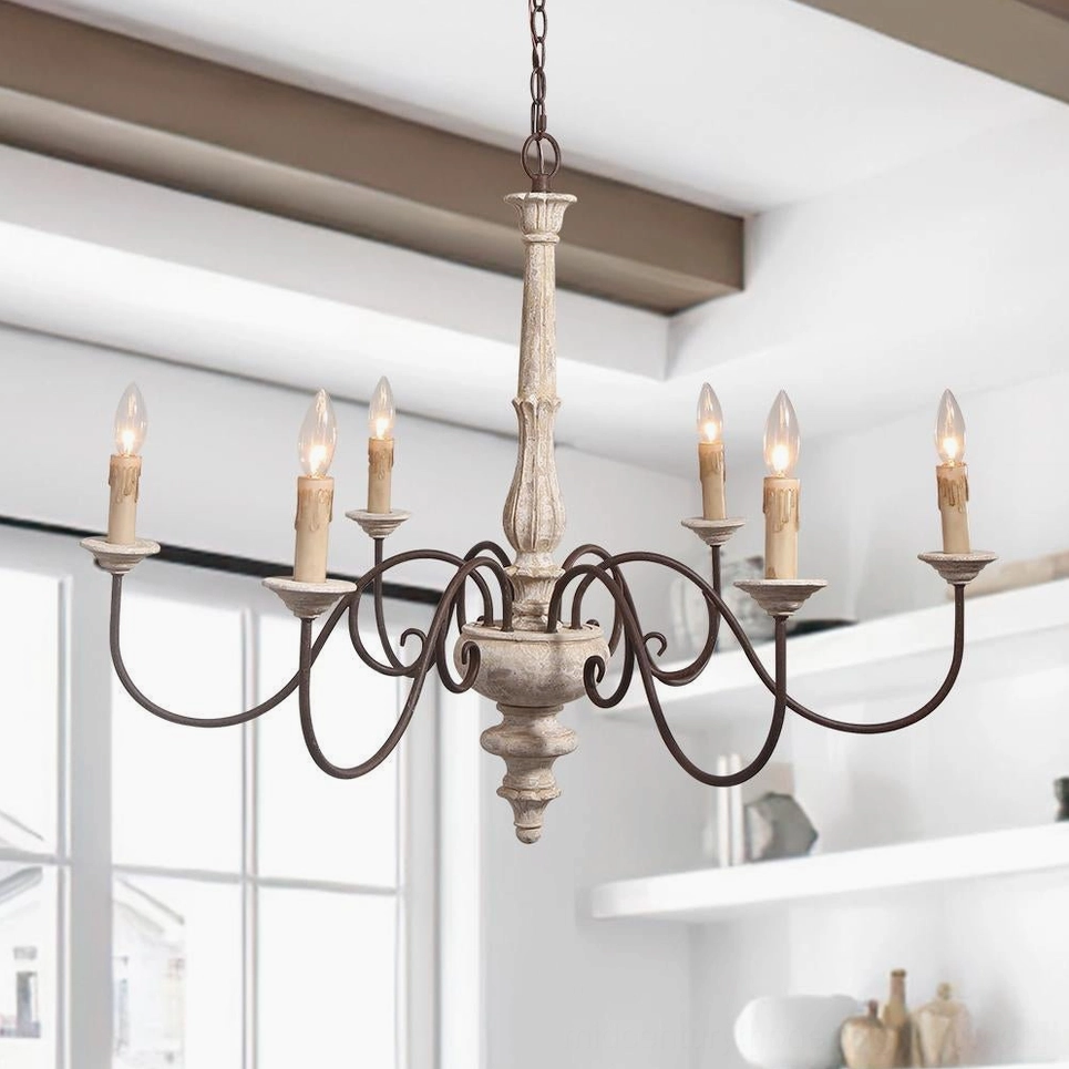 Large anchor chandelier with curved black iron arms displayed in sunlit french country living room with shelving
