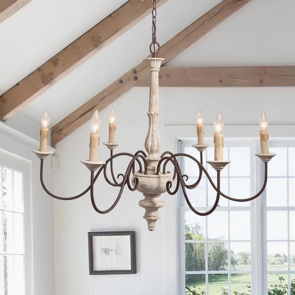 Anchor chandelier hanging in sunlit attic living room with exposed beams and rustic country aesthetic