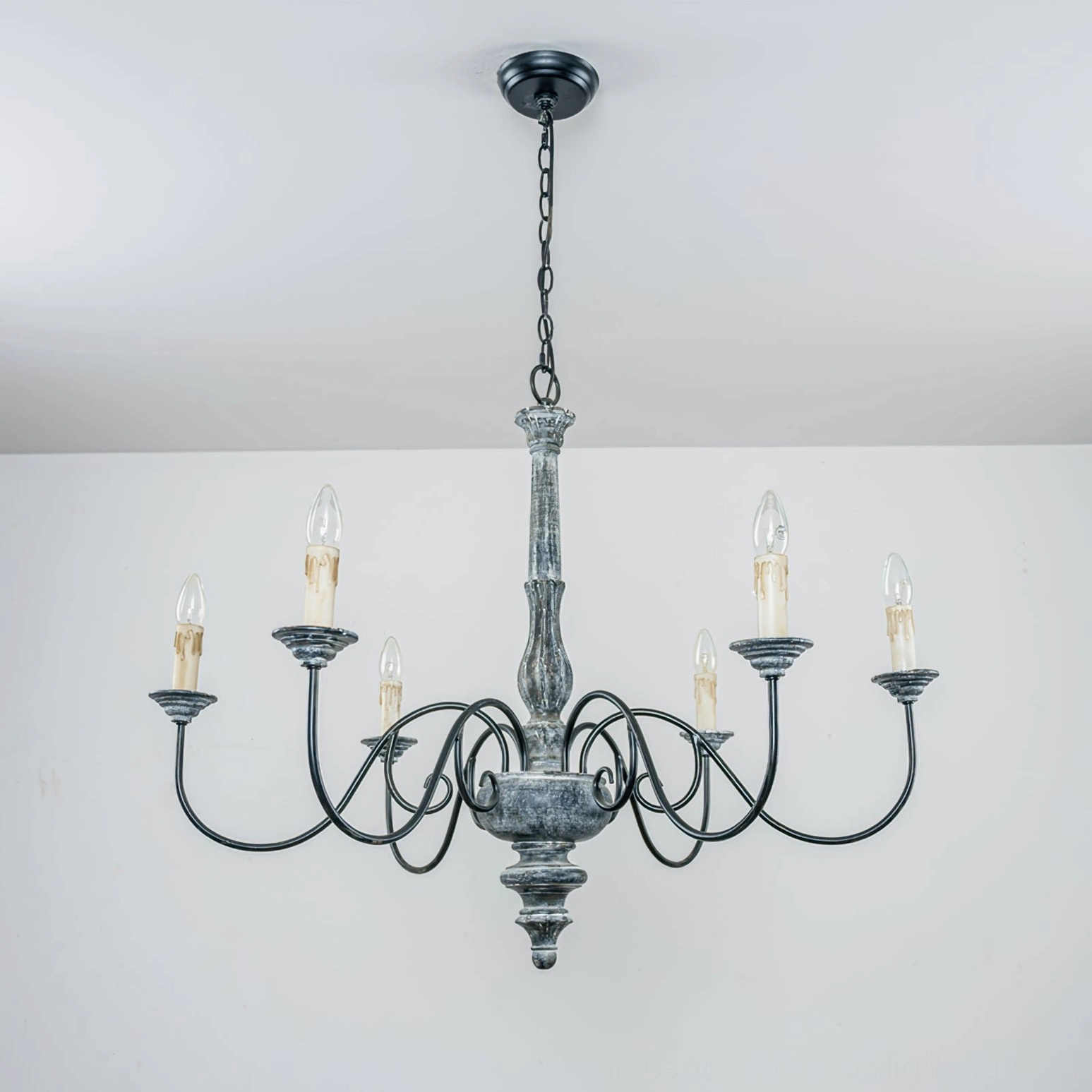 Anchor chandelier three-quarter view of wooden column and curved metal arm assembly