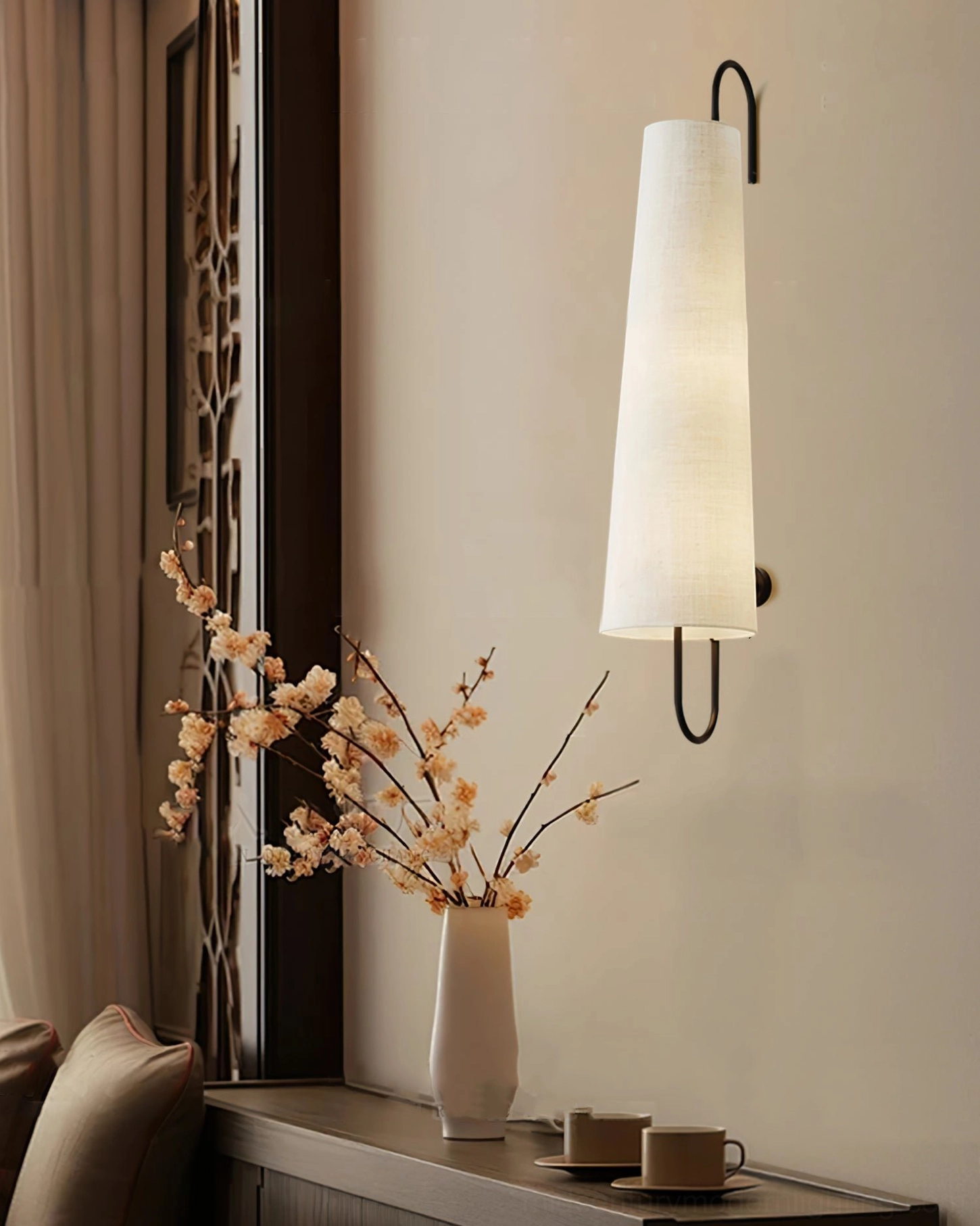 Ancora wall lamp above cozy dining nook corner with floral vase, tableware and warm neutral interior ambiance