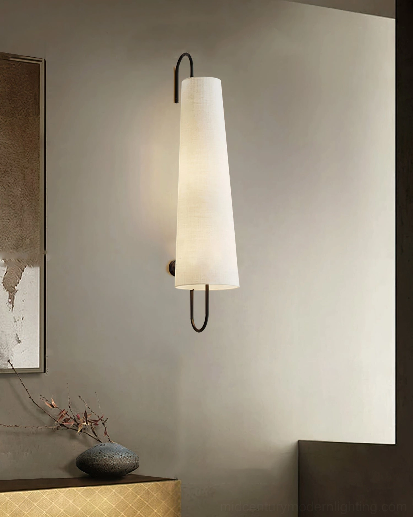 Ancora wall lamp in modern minimalist entryway with mat, wall art, and floral decor creating welcoming atmosphere