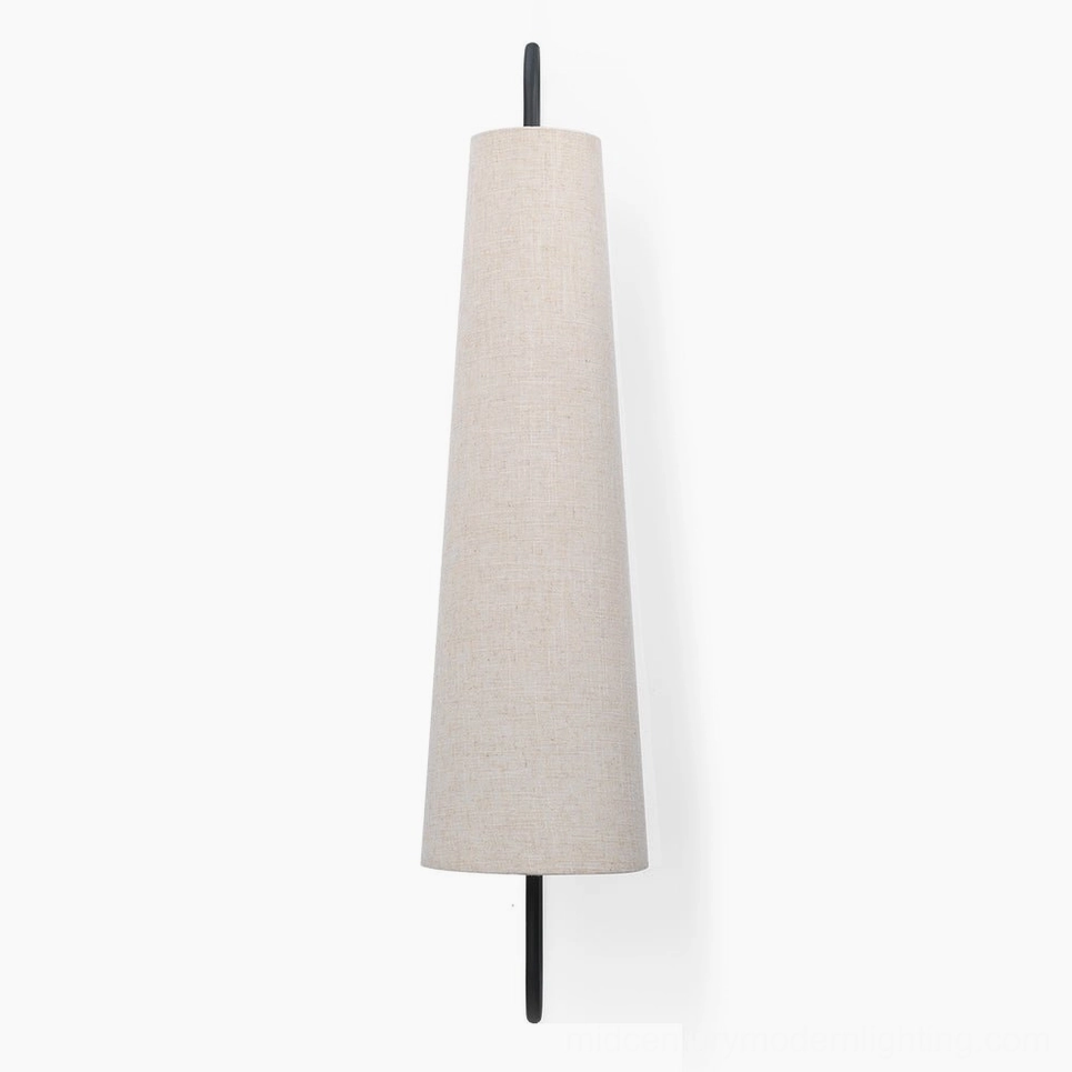 Ancora wall lamp close-up showing premium linen shade quality and metal bracket finish in modern home setting