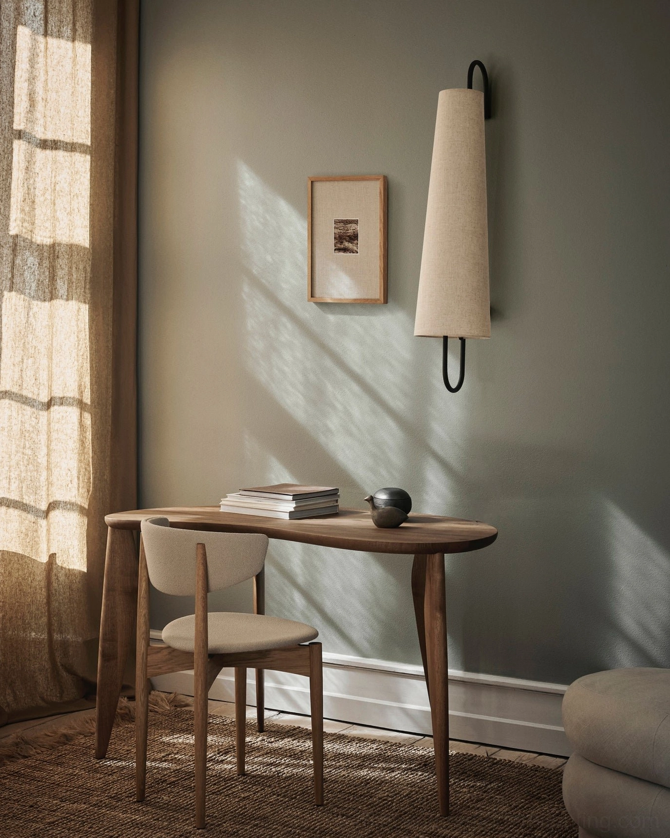 Ancora wall lamp mounted on light gray wall with wall art, casting soft natural sunlight shadows in minimalist home interior