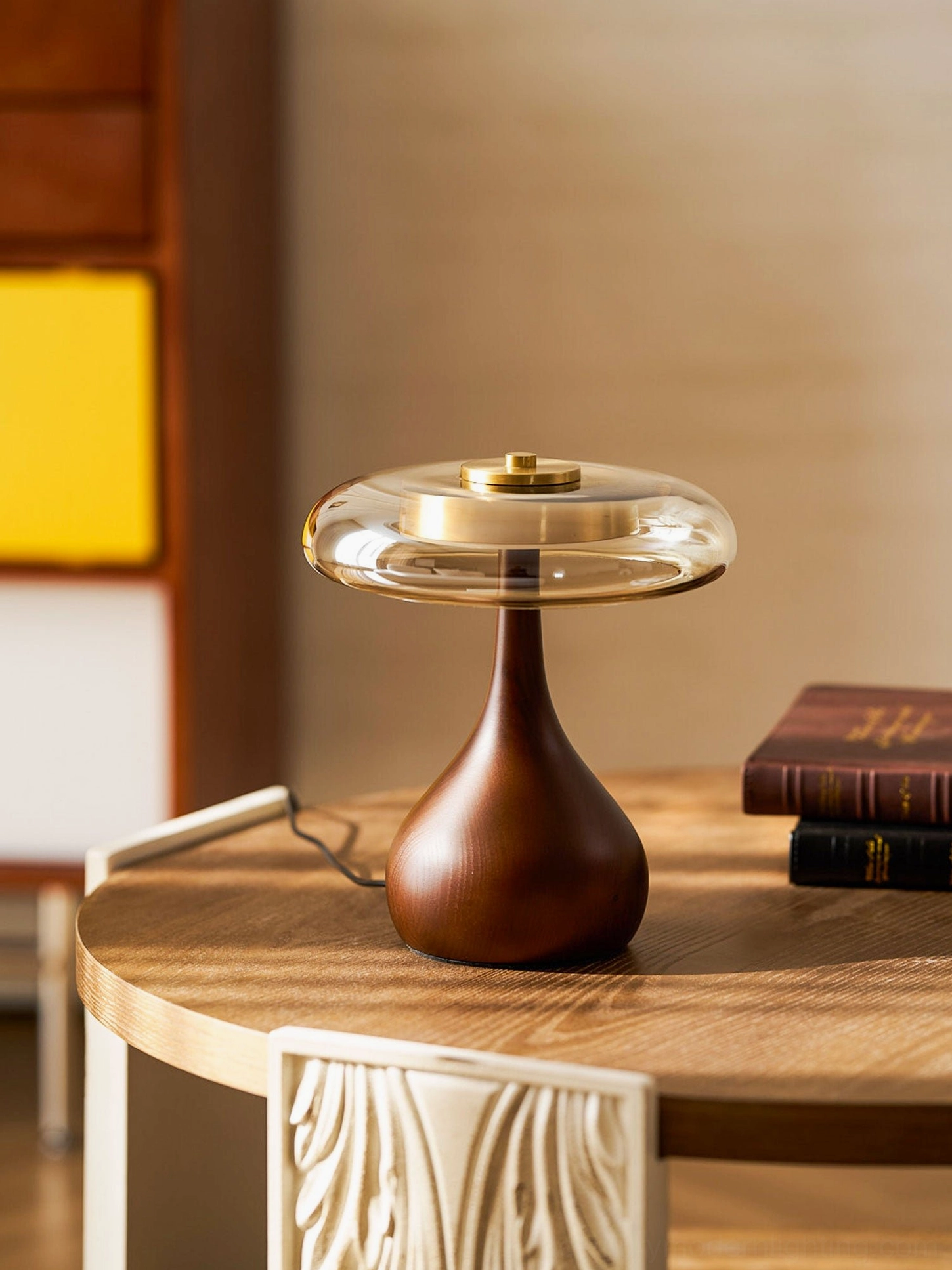 Andi Glass Table Lamp compact size on round wooden dining table with decorative side table