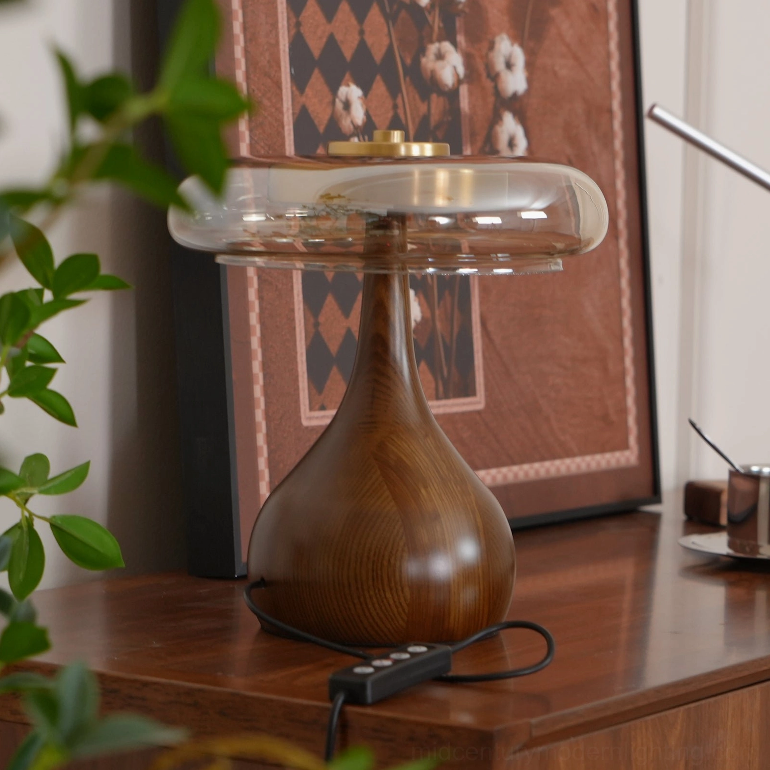 Andi mid-century table lamp showing architectural brass frame and glass shade construction