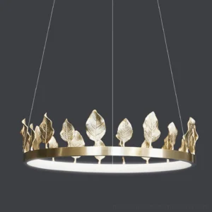 Close-up detail of hand-applied brass leaf ornaments on Anello chandelier ring
