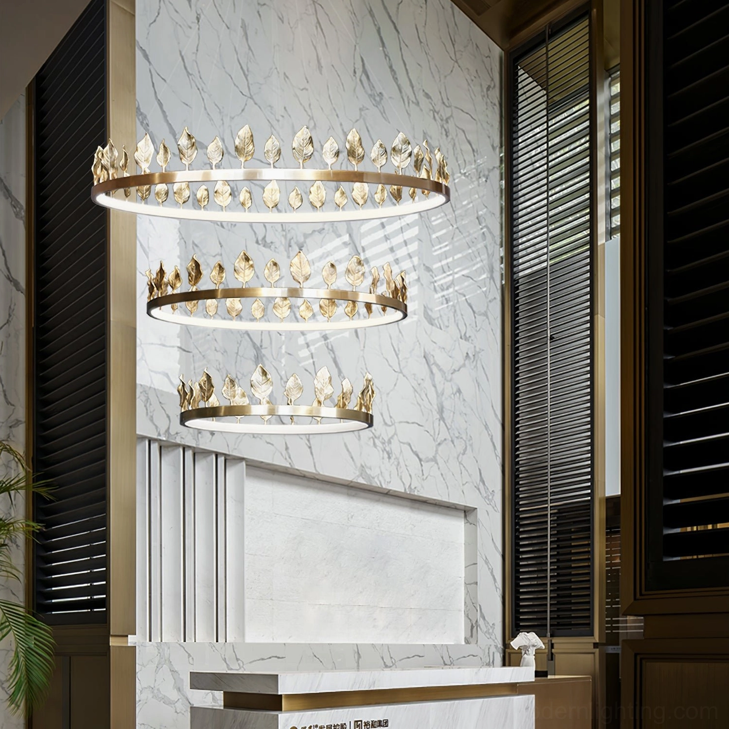 Anello leaf pendant chandelier installed in luxury marble foyer with dark wood architectural trim