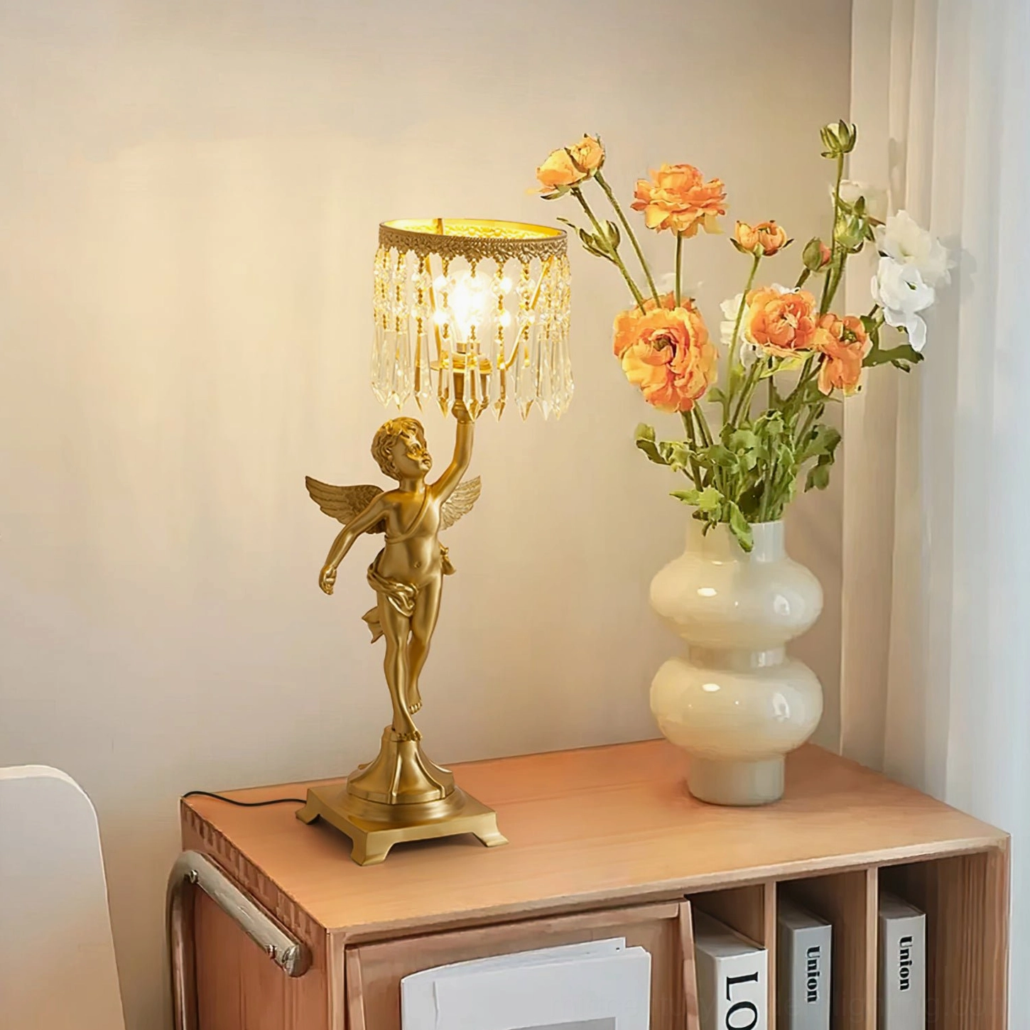 Angel crystal table lamp styled on home cabinet with flower vase, warm ambient lighting creating cozy luxury interior scene
