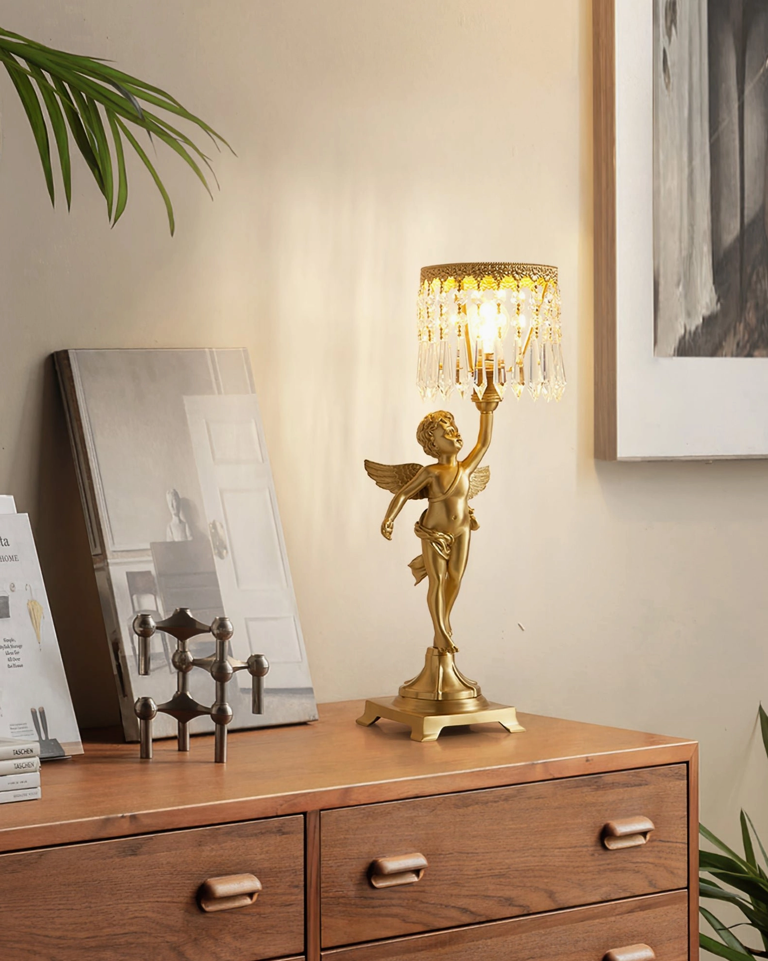 Side view of angel crystal table lamp on home dresser with wall art and cozy warm ambient home style aesthetic