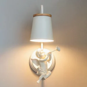 Celestial angel wall light fixture with warm glowing illumination and wood-trimmed fabric shade on grey interior wall