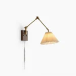 Angeline swing arm wall lamp front view, brass and walnut mid-century modern design with pleated fabric shade, studio lighting
