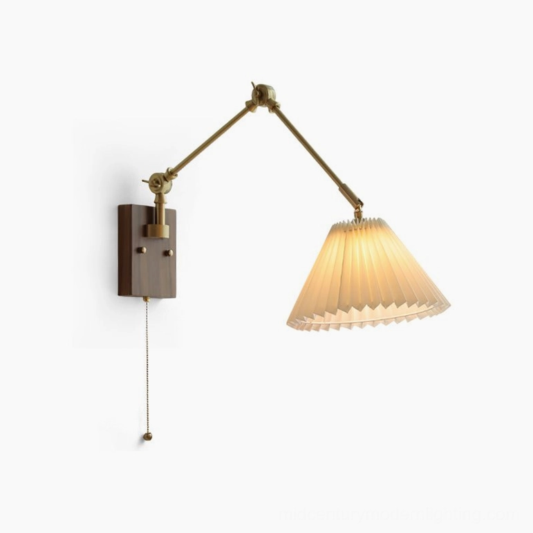 Angeline swing arm wall lamp with lit warm pleated shade, frontal flat view on white background showing consistent design consistency and pleating texture