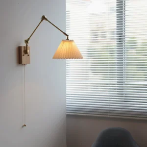Angeline swing arm wall lamp installed in minimalist study room with louvered window, demonstrating warm lighting and three-quarter perspective with zipper pull cord switch