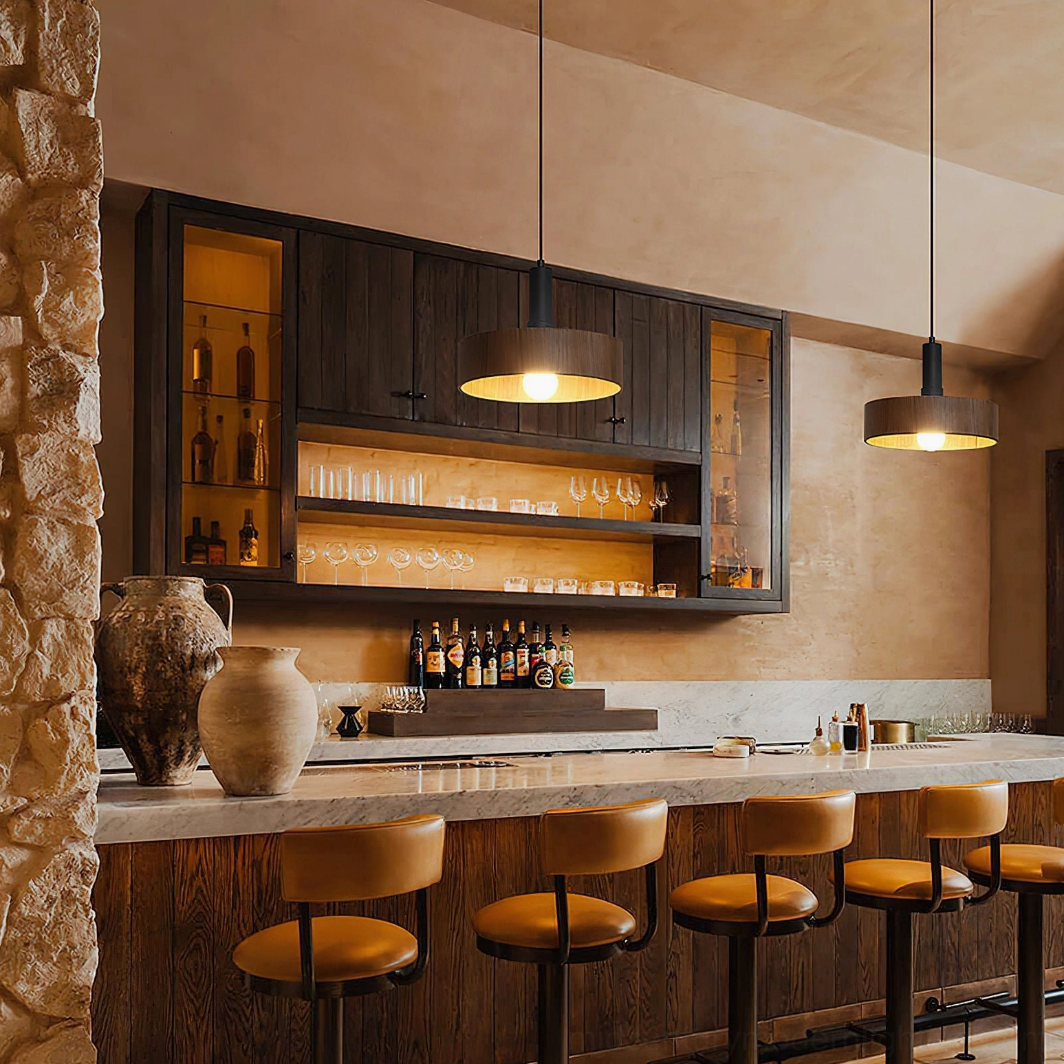Two Angilia pendant lights suspended over restaurant bar counter, warm wood finishes providing focused task lighting and ambient glow