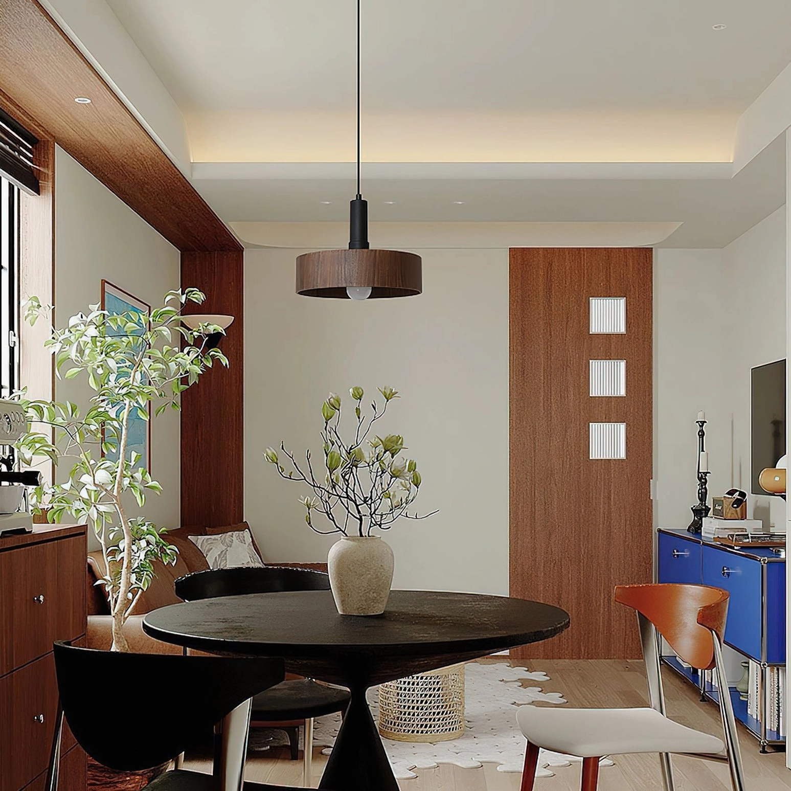 Angilia pendant light installed above dining table in modern home interior, warm ambient lighting creating intimate dinner atmosphere