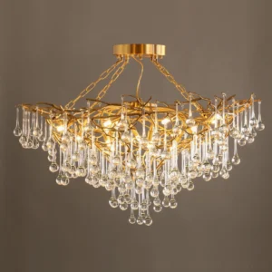 Close-up of Anita brass chandelier with polished gold finish and crystal pendants, luxury detail shot