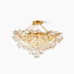 Anita gold leaf crystal chandelier with brass frame and clear crystal drops, frontal studio view