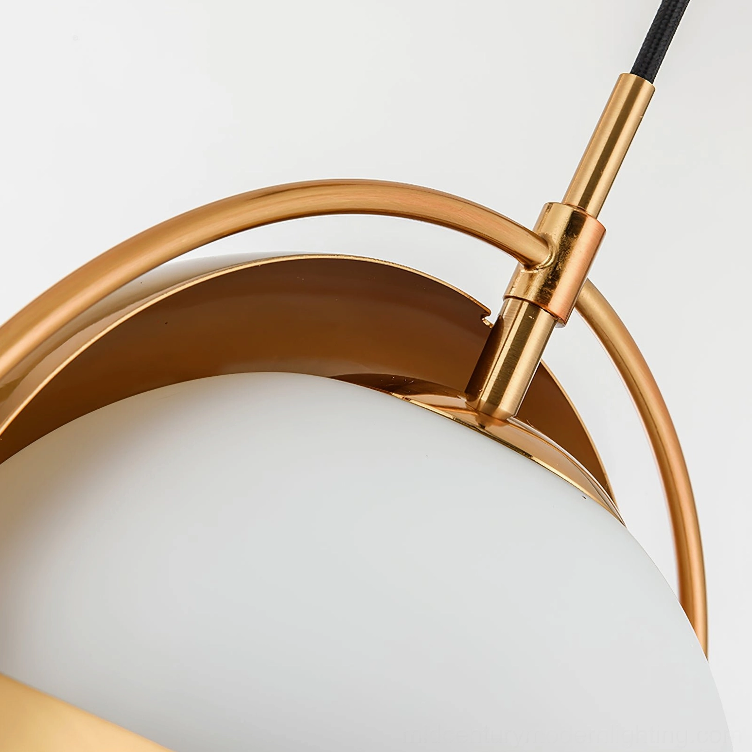 Warm brass Anix interactive pendant light installed in modern residential bedroom space