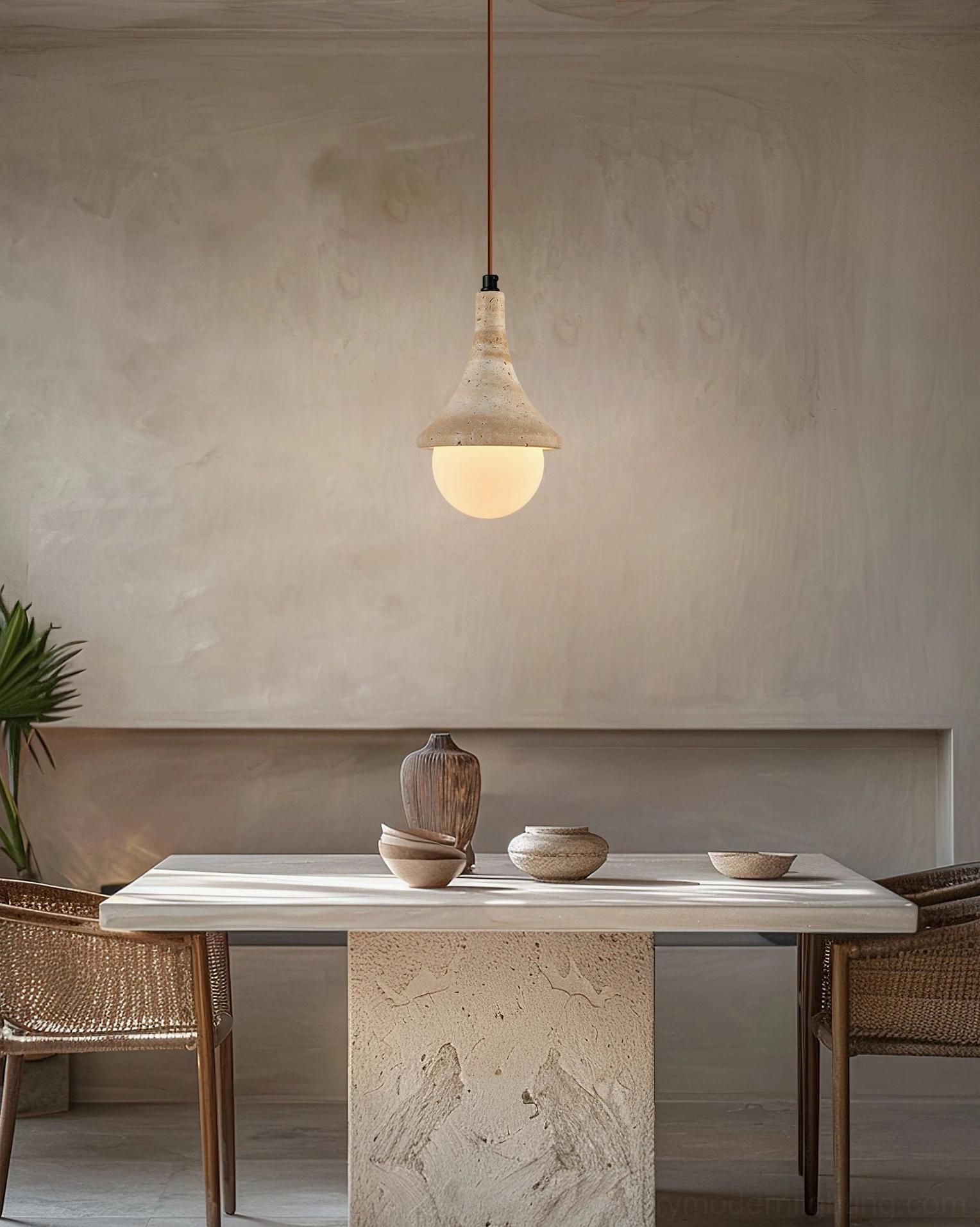 Annadel travertine pendant suspended in dining room with minimalist rustic interior design and natural lighting