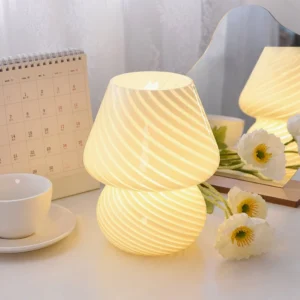 Glowing striped mushroom textured table lamp on home desk with warm beige tone and floral decor
