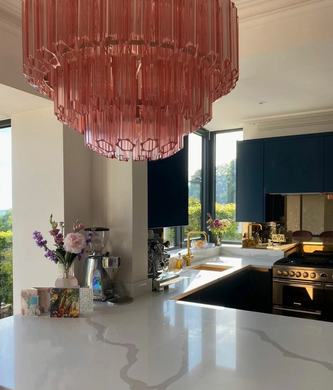 Antella Sunburst Chandelier architectural detail - pink hand-blown glass panels with geometric cutout apertures creating sculptural shadow patterns