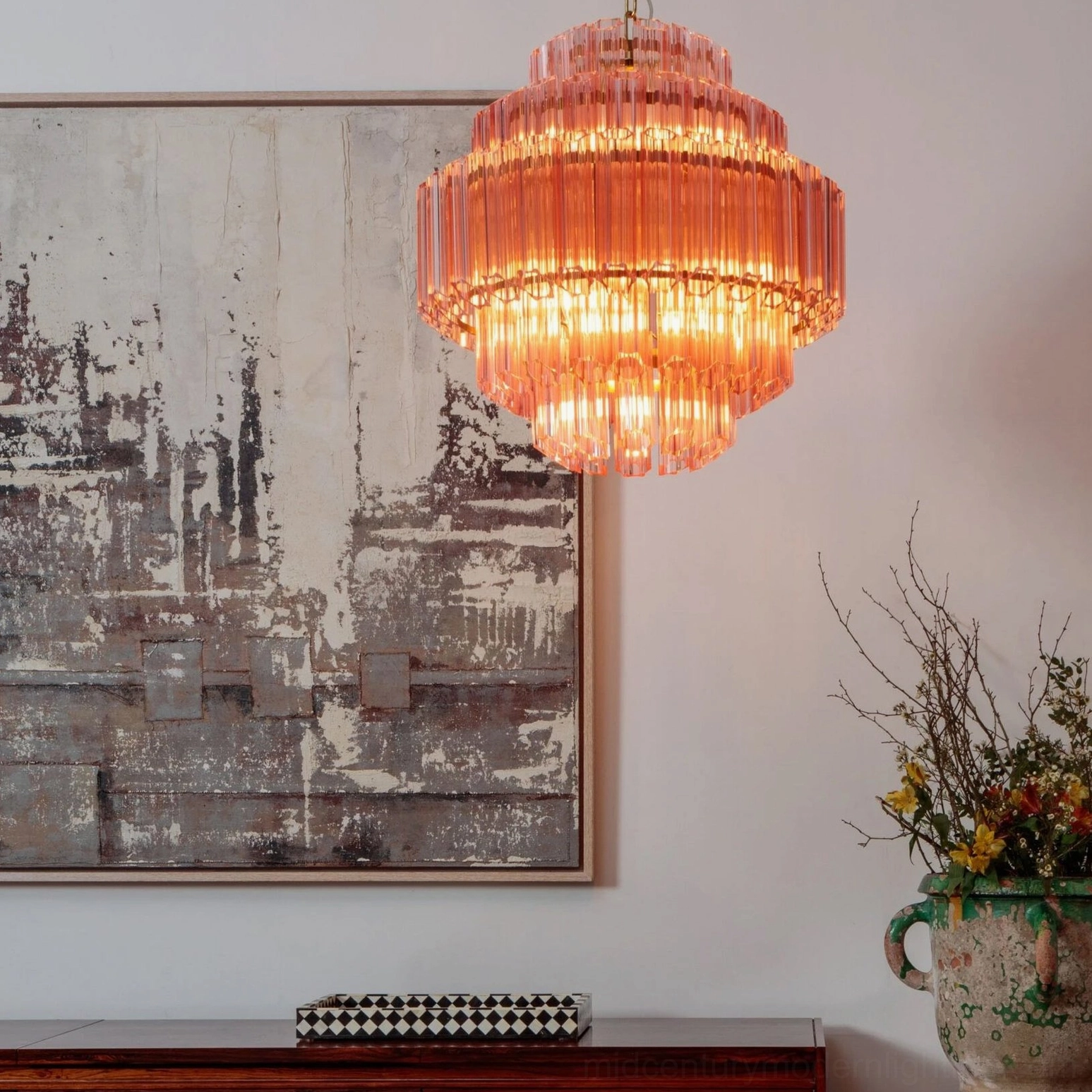 Antella Sunburst Chandelier in luxury home foyer - pink tiered glass pendant lighting fixture in elegant interior with abstract wall art