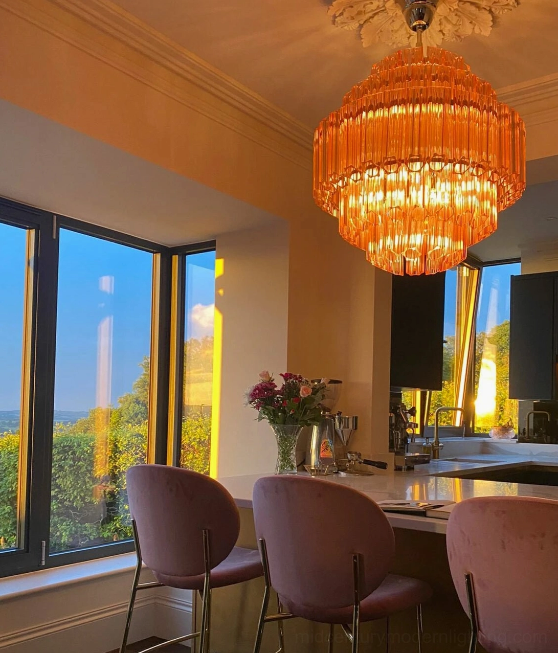 Antella Sunburst Chandelier lighting performance - pink Murano glass tiered chandelier illuminated showing ambient warm glow and light diffusion