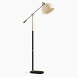 Anthony mid-century modern floor lamp with pleated fabric shade and adjustable swing arm, featuring black metal pole with brass details on white background