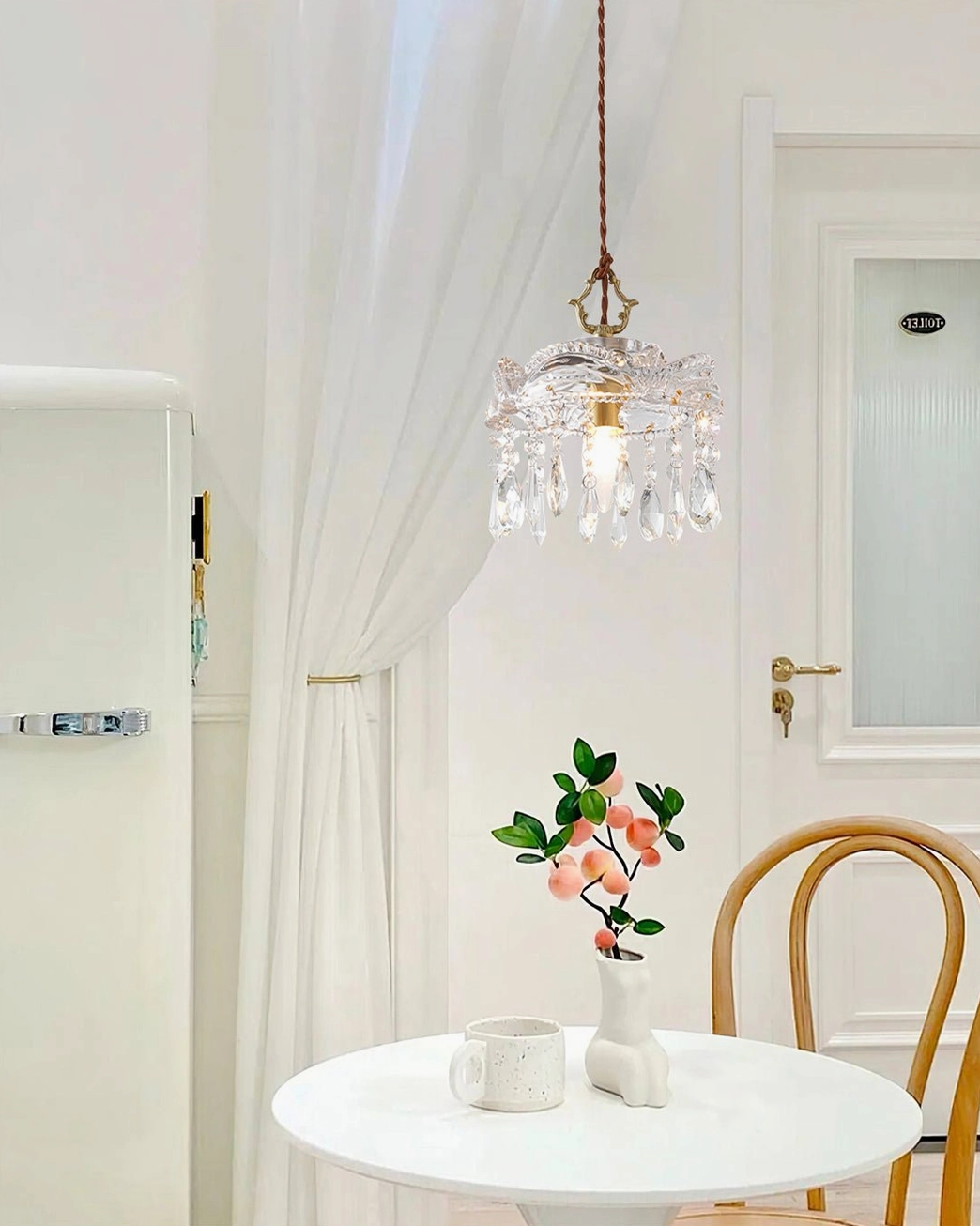 Antigua crystal pendant lamp showing brass framework and suspended crystal beads, side view