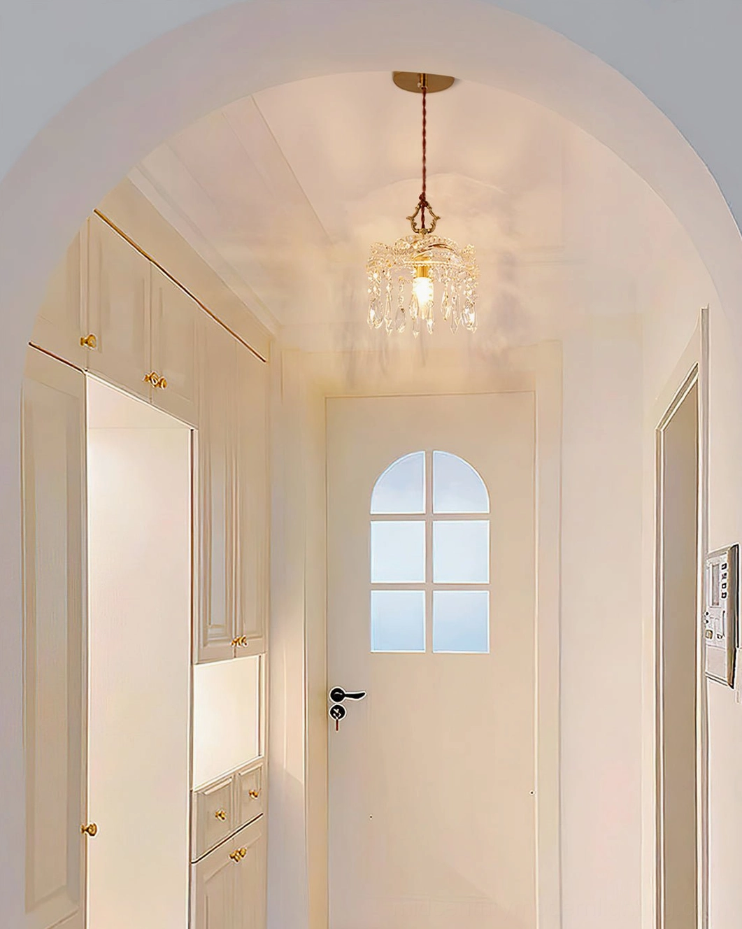 Hanging crystal pendant with warm ambient lighting, brass and clear glass fixture in modern interior