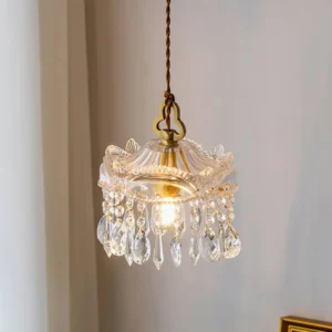 Vintage brass crystal pendant chandelier hanging from twisted cord with tassel crystal accents, interior corner view