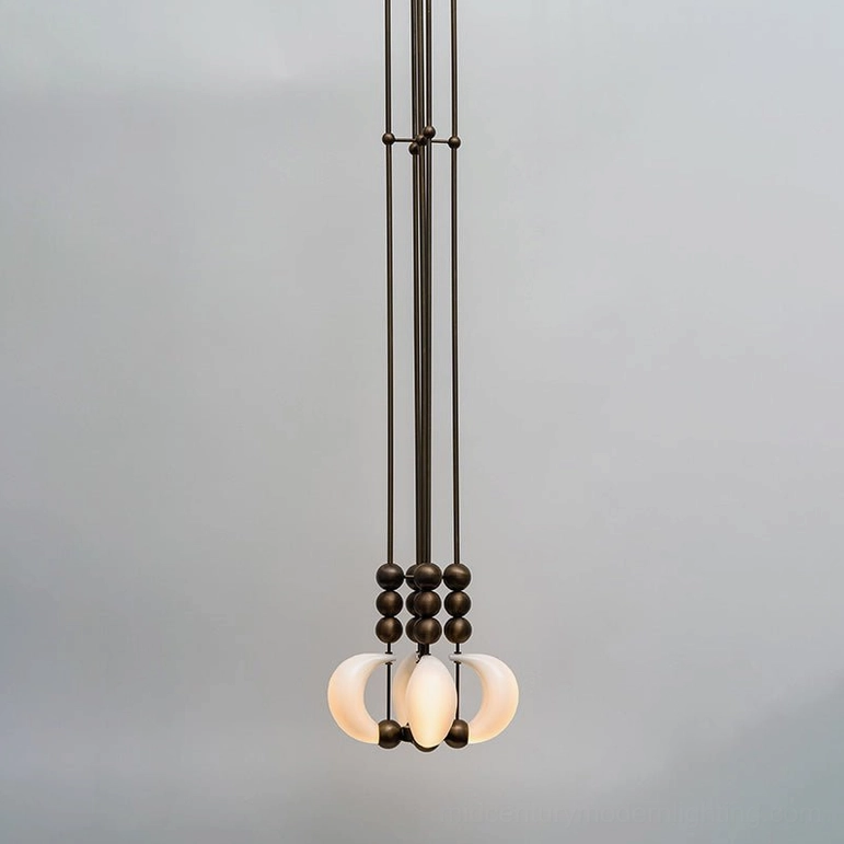 Small antique brass curved glass pendant light with dark bronze spherical beads and milky white shade - modern sculptural fixture