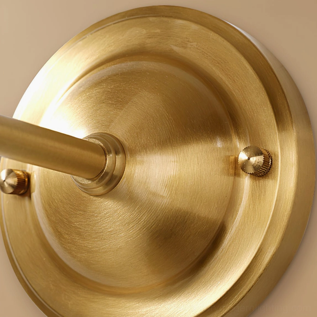 Antique brass wall sconce with brass-tone linen shade showing warm tonal monochromatic finish
