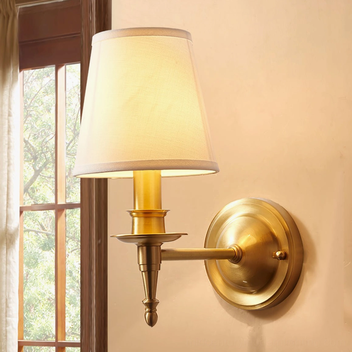 Antique brass wall sconce installation detail with brass patina finish visible in side profile