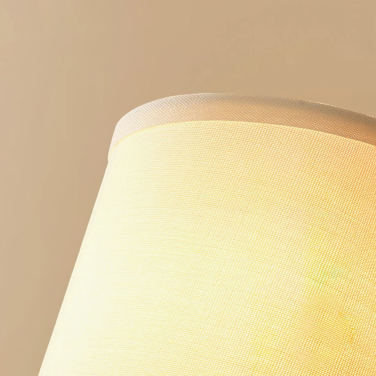 Antique brass wall sconce with white linen shade variant in neutral interior setting