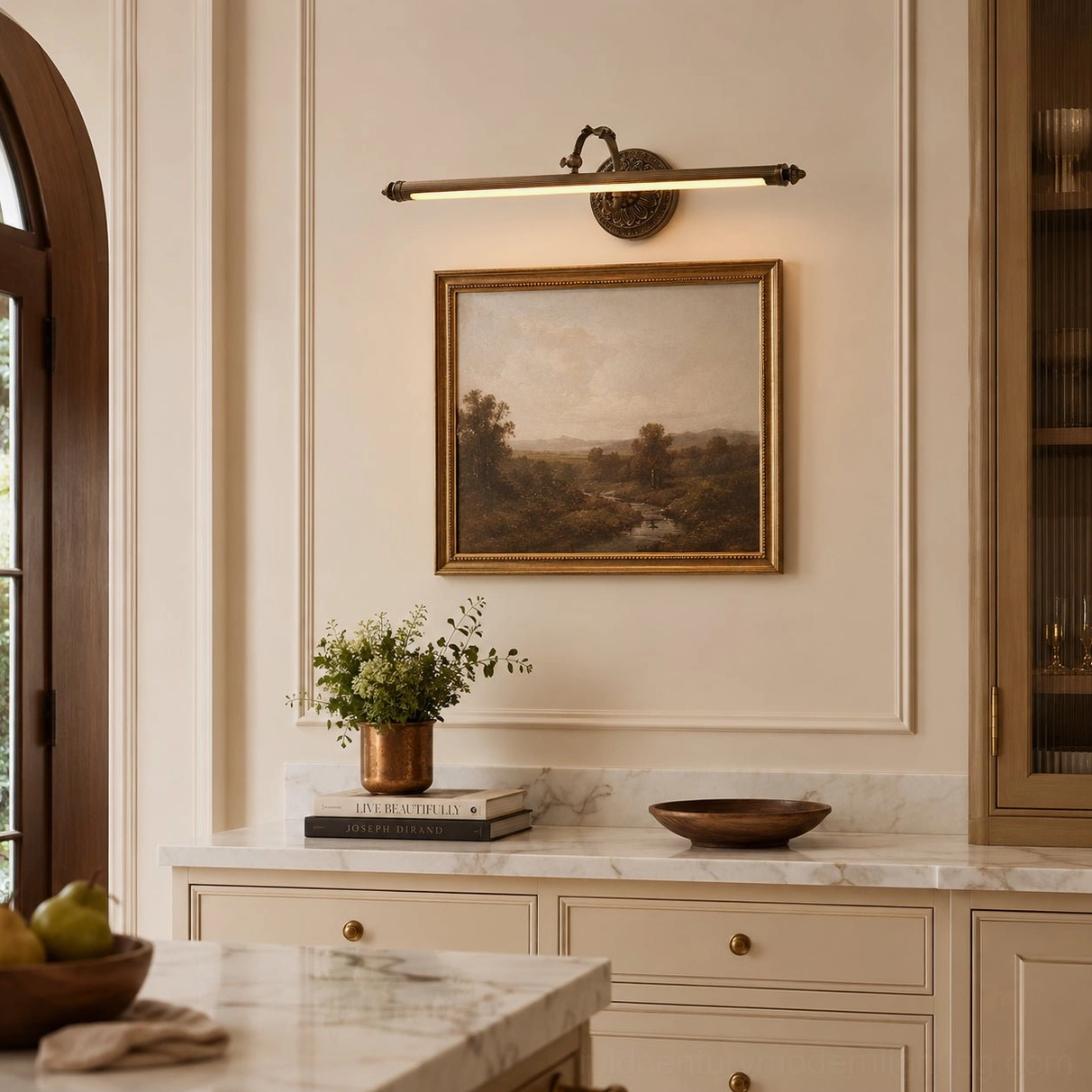 Antique brass wall sconce with classical finials in vintage-inspired bathroom vanity setting