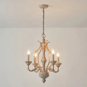 Vintage antique white chandelier with warm glowing candle bulbs, overhead illuminated perspective
