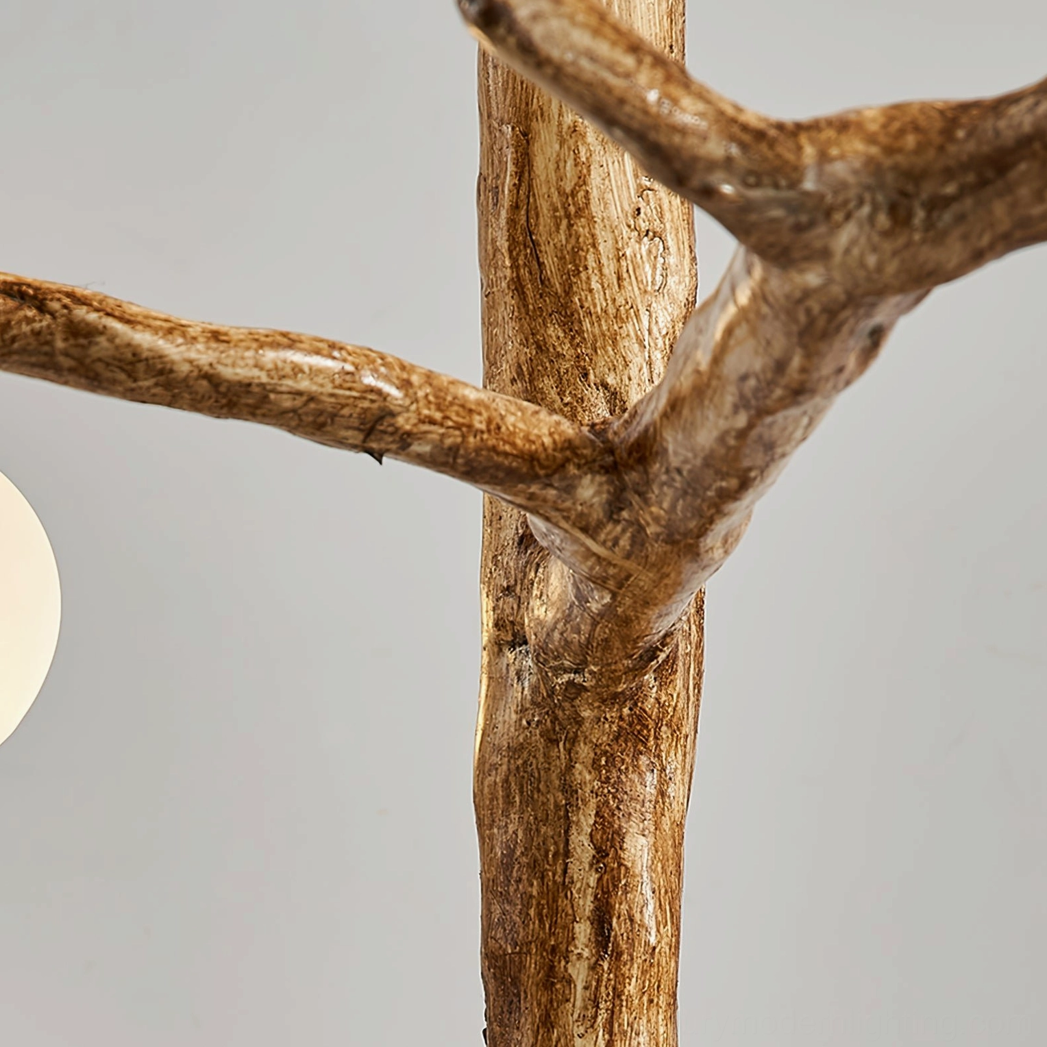 detailed close-up of antler floor lamp metal branches showing realistic wood grain texture and sculptural craftsmanship of walnut-finished frame