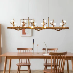Antler branch pendant chandelier side view installed in minimalist farmhouse rustic dining room with warm lighting