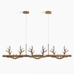 Antler branch linear chandelier overhead view studio shot with walnut wood-grain finish and frosted glass bulbs on white background