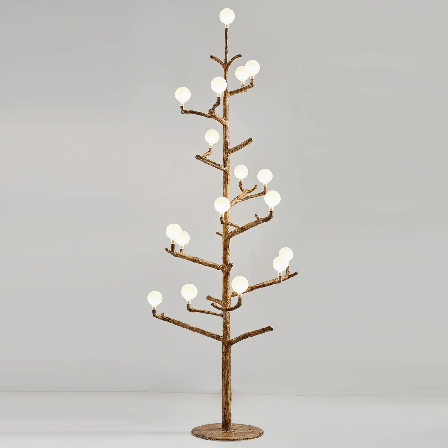 lit antler floor lamp creating warm ambient glow, demonstrating the silhouette of tree-form branching structure with illuminated warm white bulbs