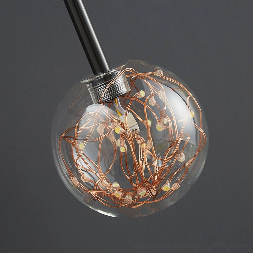 Glass pendant sphere with copper string LED lights inside antler wall sconce macro view