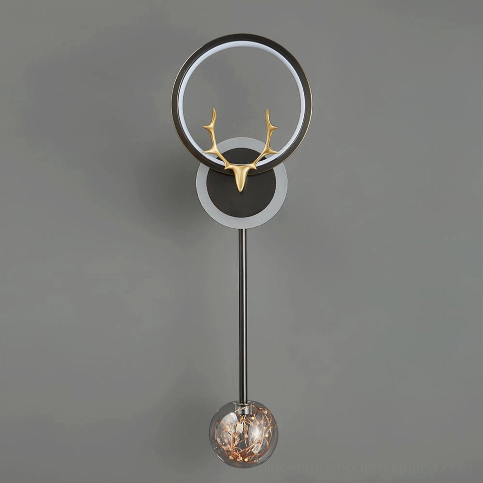 Antler wall sconce close-up showing premium brass construction, acrylic details and glass pendant