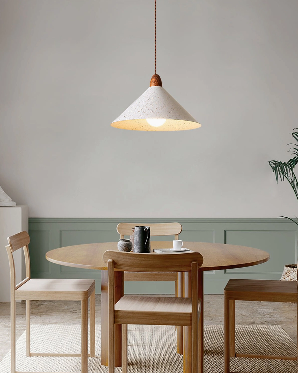 Single Anye pendant lamp hanging in contemporary bedroom with wooden flooring and minimalist furnishings