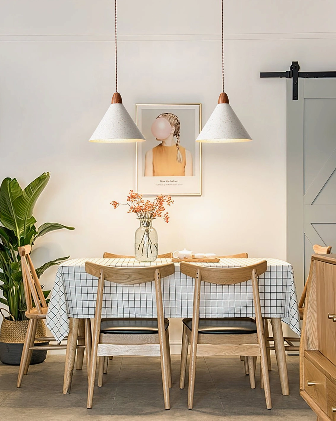 Dual Anye pendant lights suspended above farmhouse dining space with checkered tablecloth and rustic decor