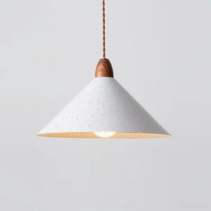 Close-up view of Anye pendant lamp showing wood grain water transfer print on cap and warm ambient glow